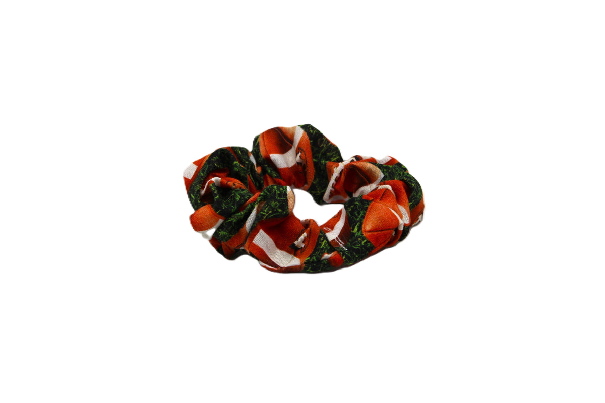 Orange and green patterned fabric scrunchie, the Dreamy Tea style, shown against a plain white background.