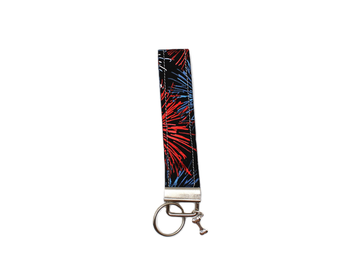 Red and blue firework patterned keychain strap with silver metal ring and clasp.