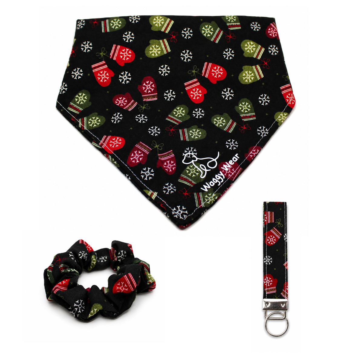 Black Waggy Wear dog bandana with red and green mittens and snowflakes, paired with matching scrunchie and keychain.