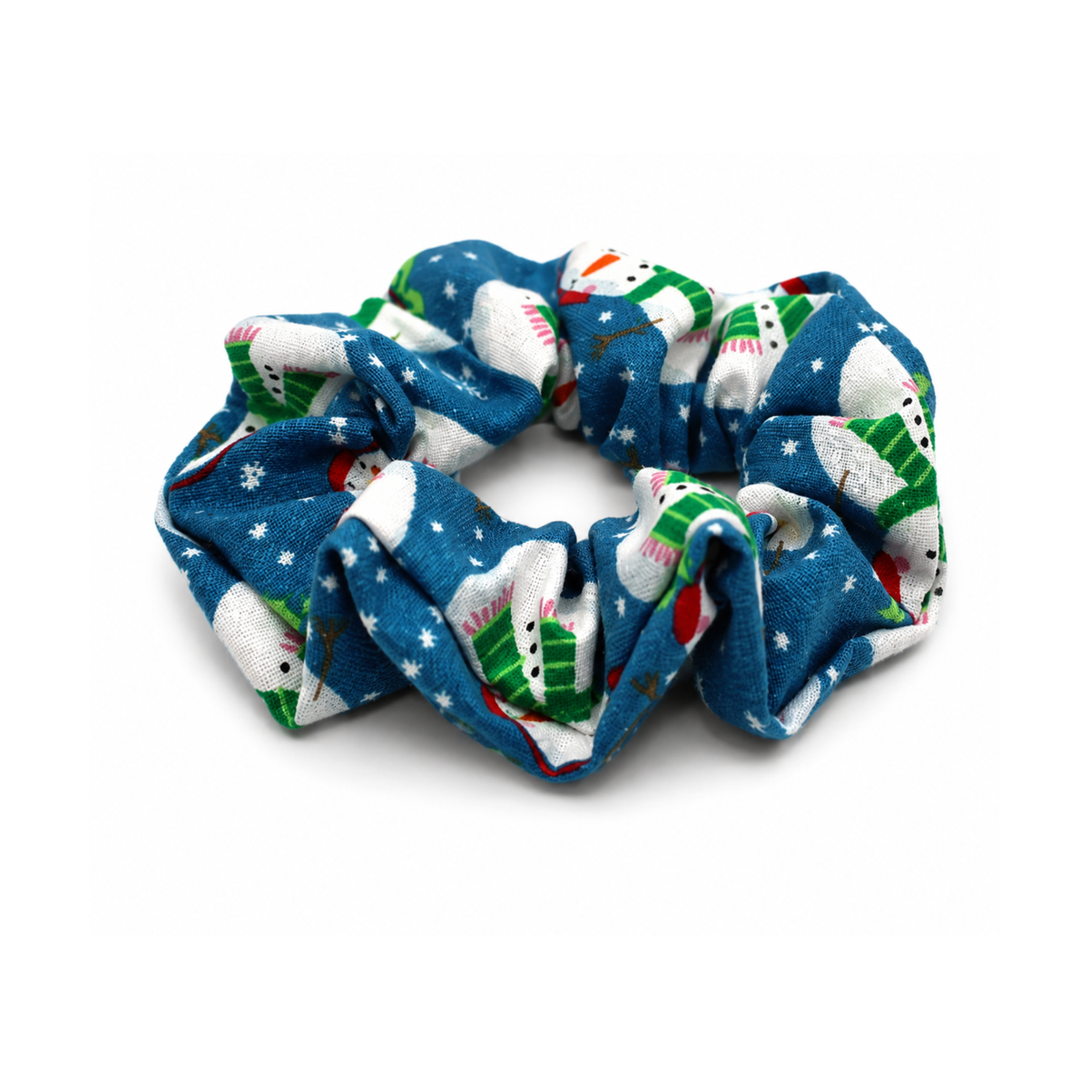 Blue fabric hair scrunchie with a festive snowman and tree print on a white background.