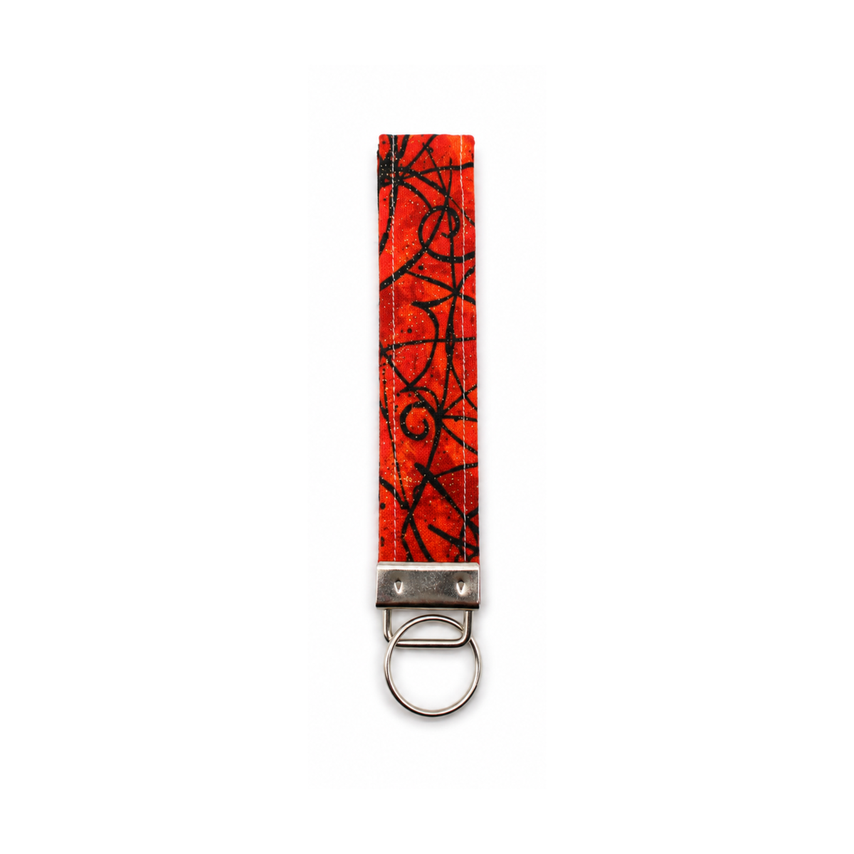 Red and black scribble patterned dog leash strap with metal key ring attachment.